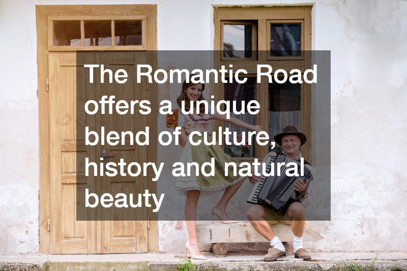 man and woman dressed in traditional german clothes posing in front of an old house